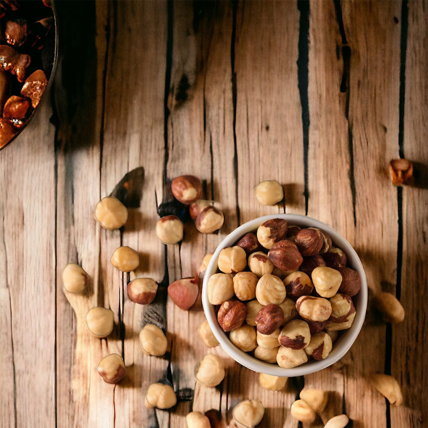 Bowl filled with shelled hazelnuts on a rustic wooden table
